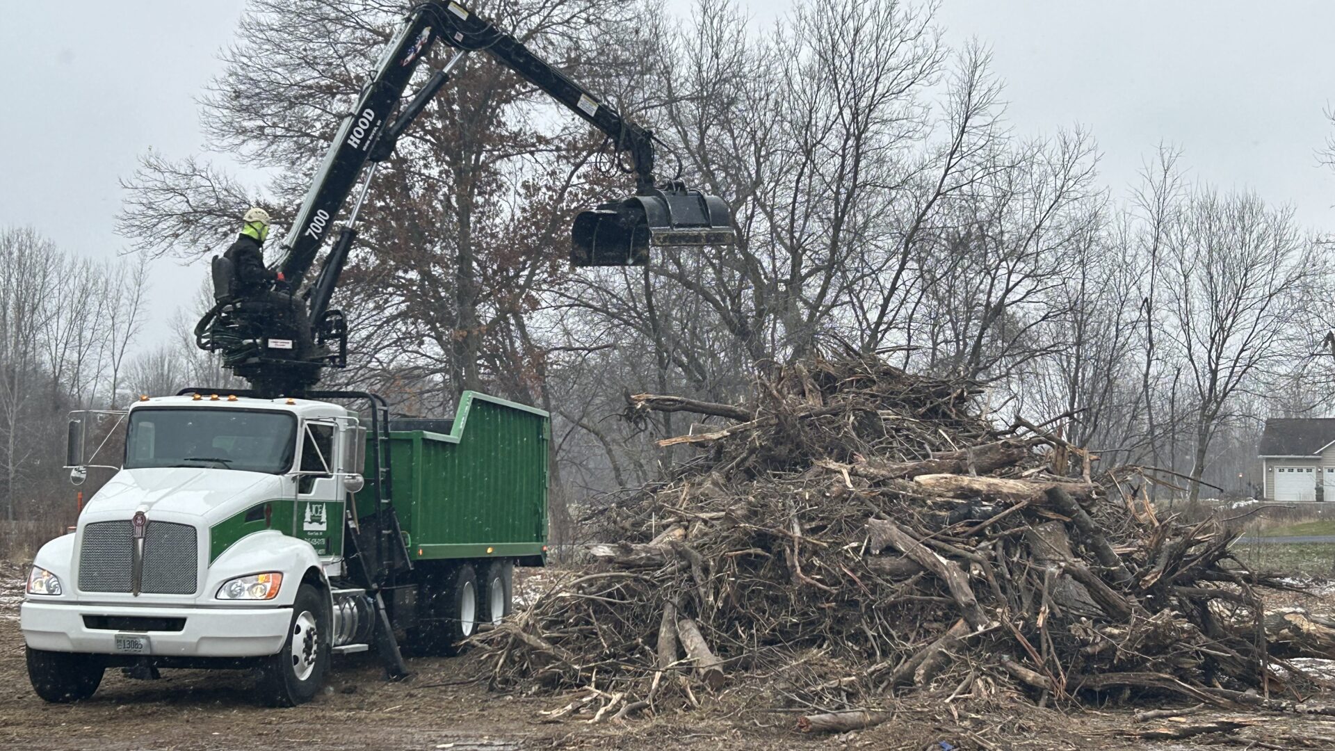 Cleaning up a brush pile with a loader truck in River Falls, WI